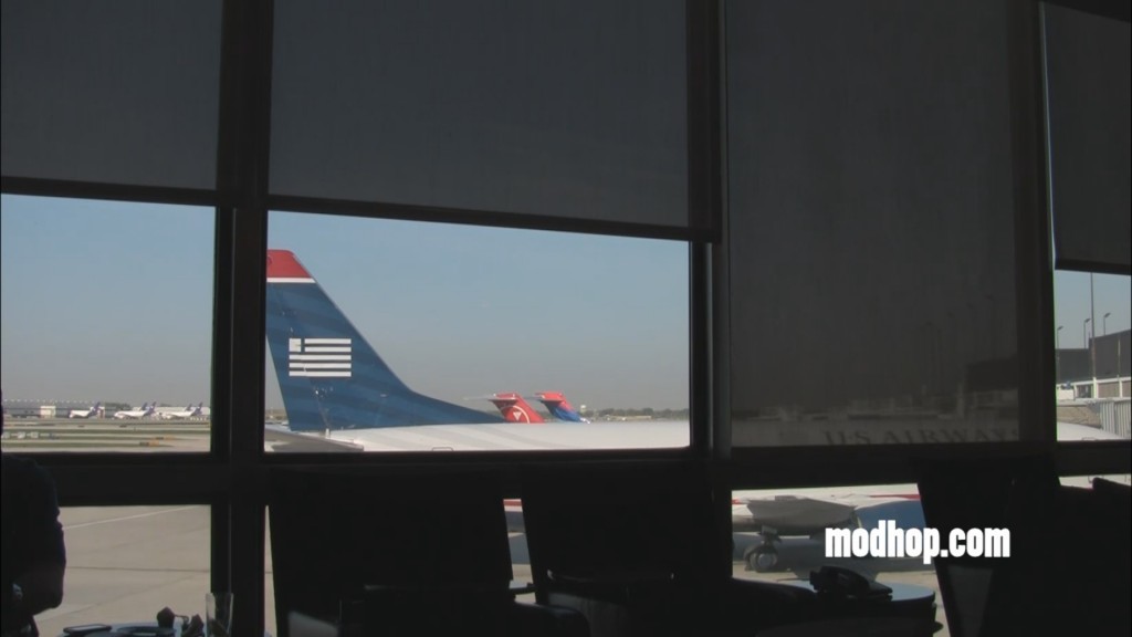 a window with a plane tail and planes in the background