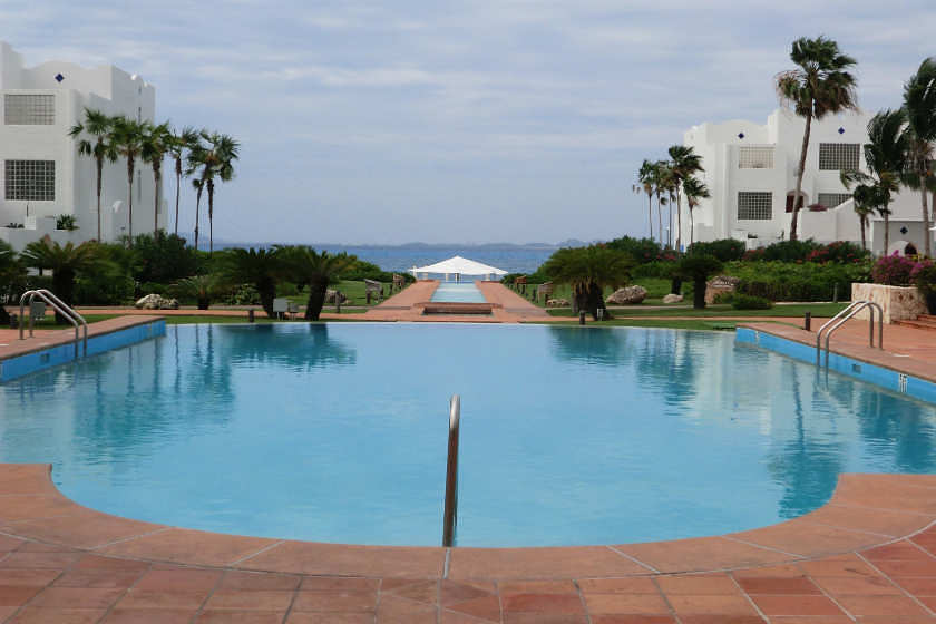 a pool with a white building in the background