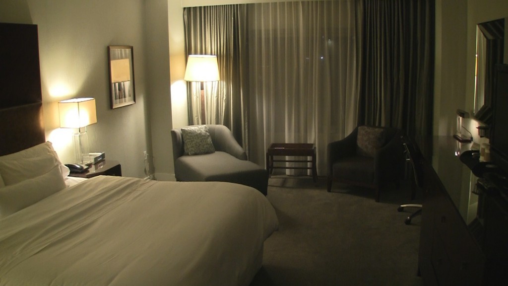 a bedroom with a bed and a lamp