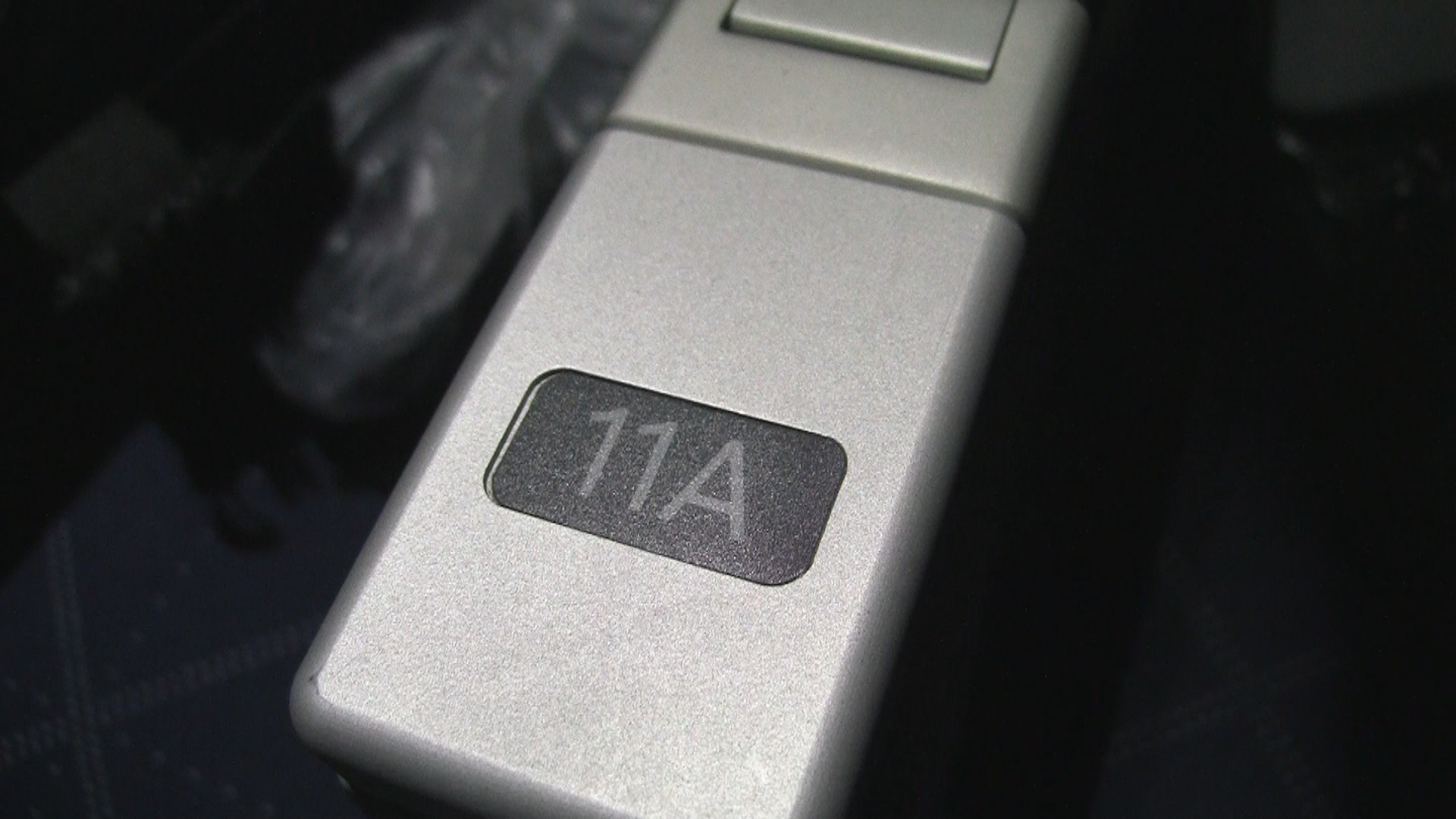 Seat 11A number printed in armrest.