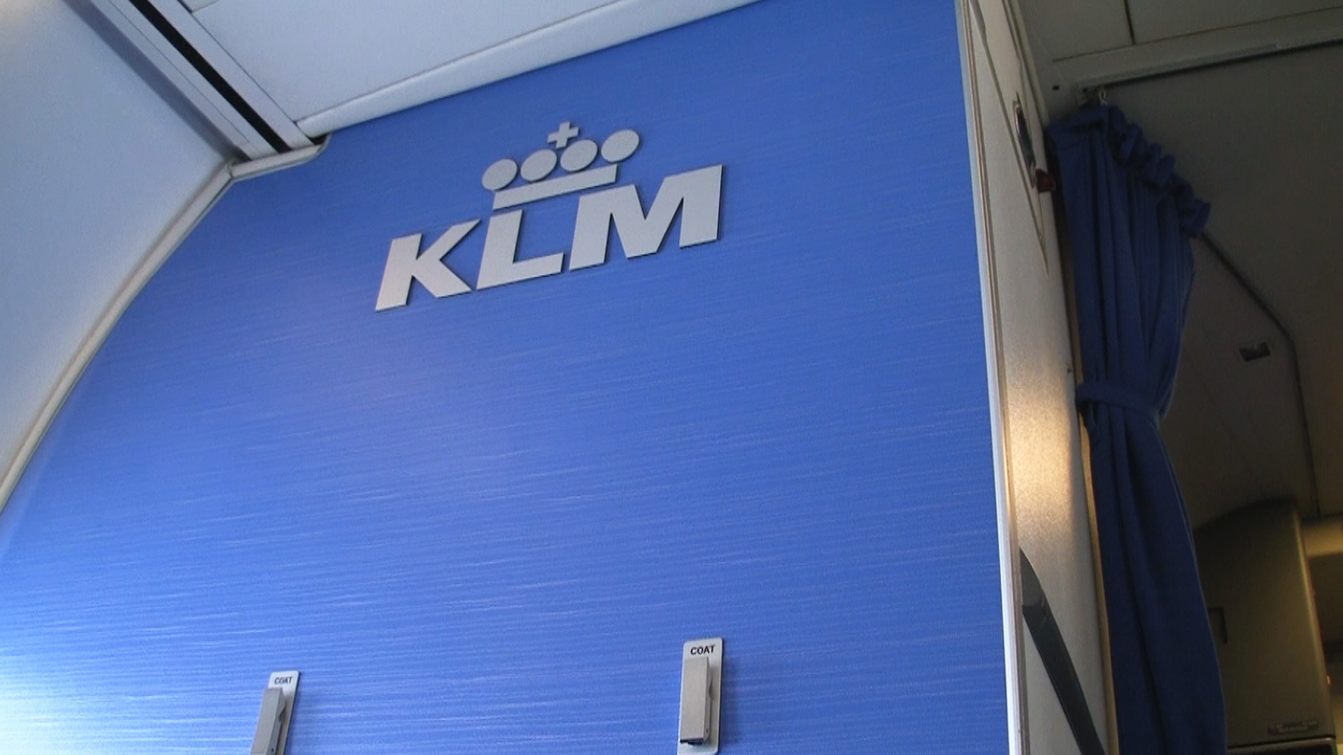 KLM Business Class with logo on bulkhead wall.