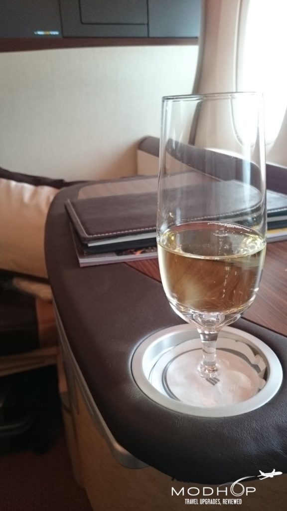 a glass of champagne on a coaster
