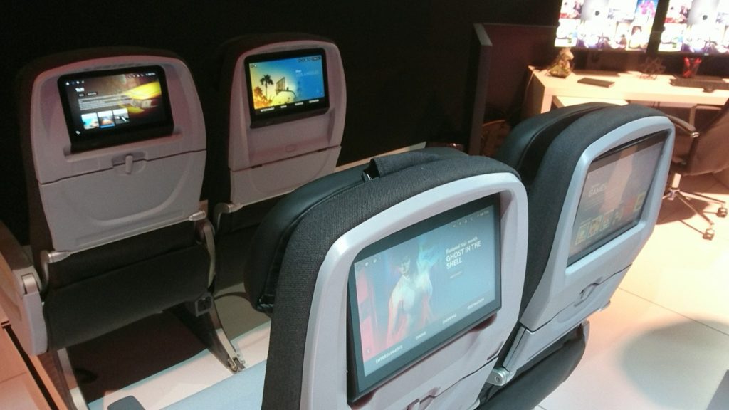 a row of seats with a screen on the back