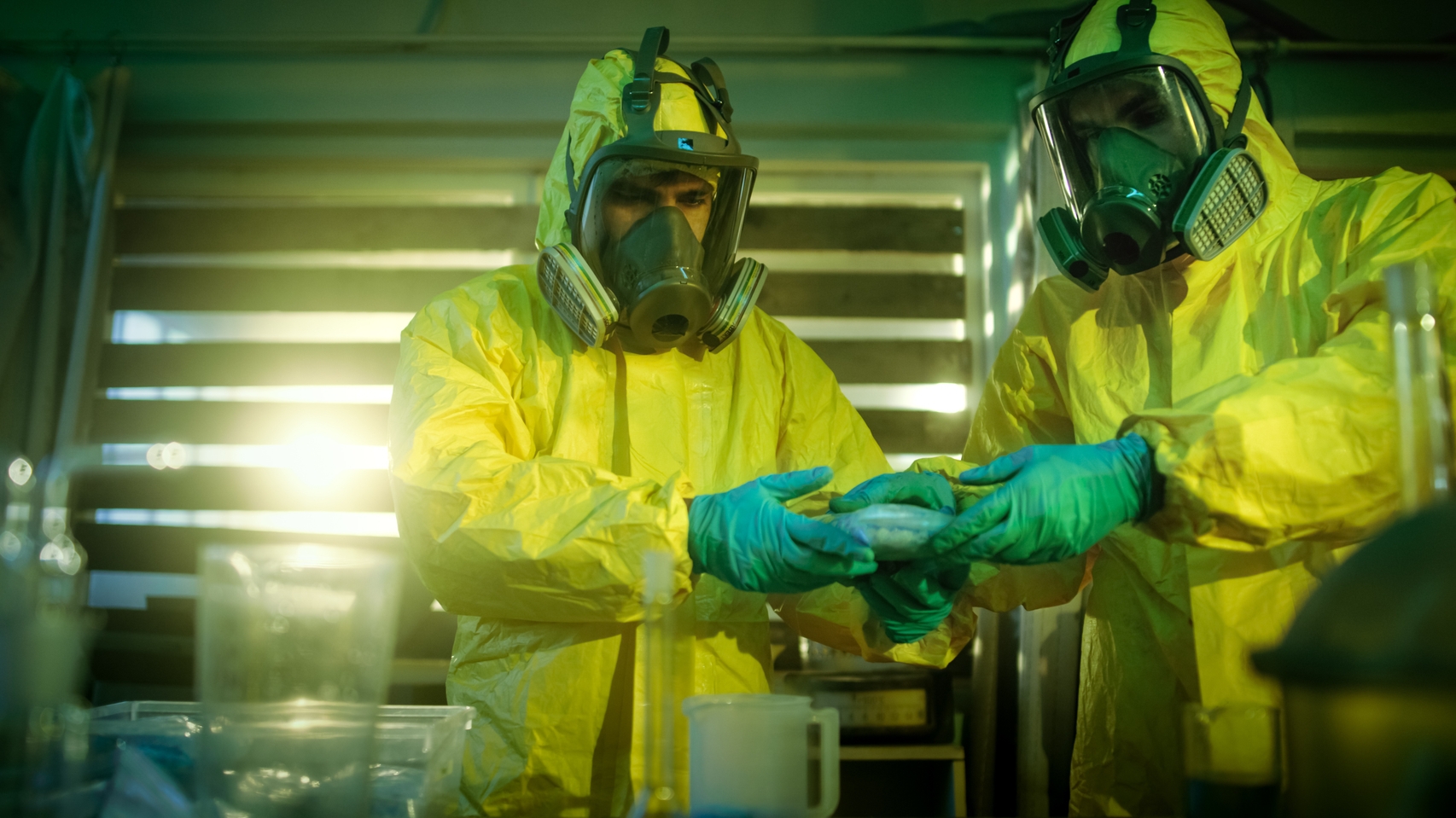 a group of people wearing hazmat suits and gloves