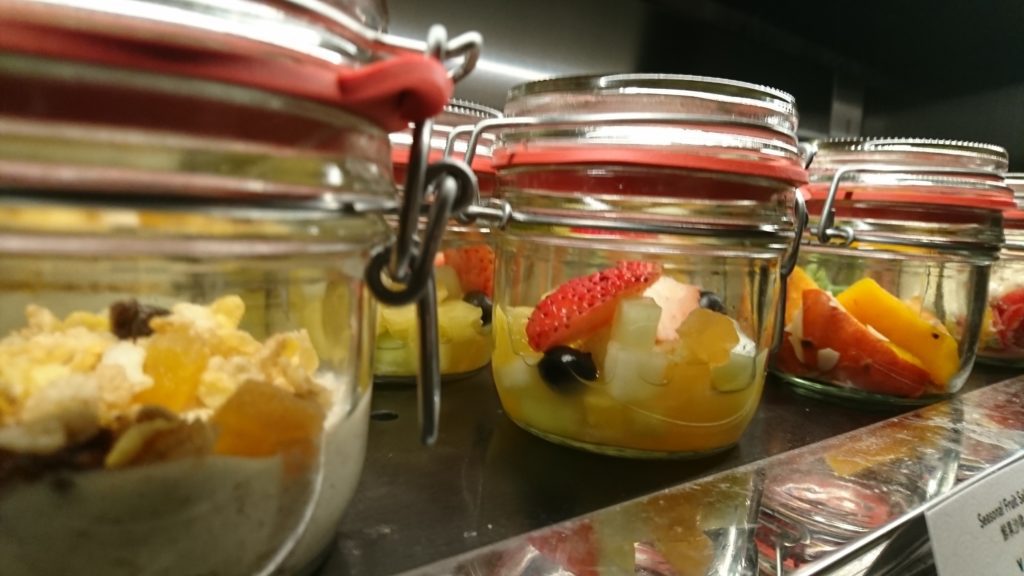 a group of jars with fruit in them