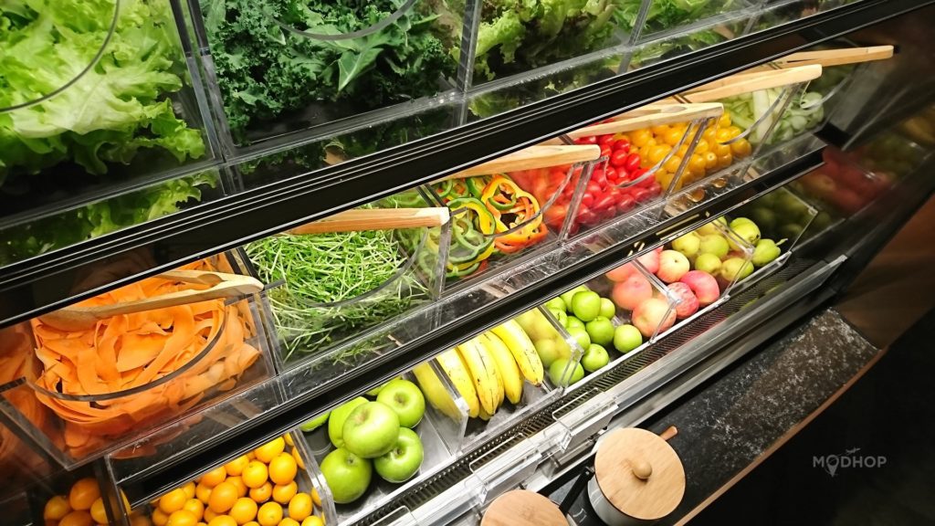 a display case of vegetables and fruits