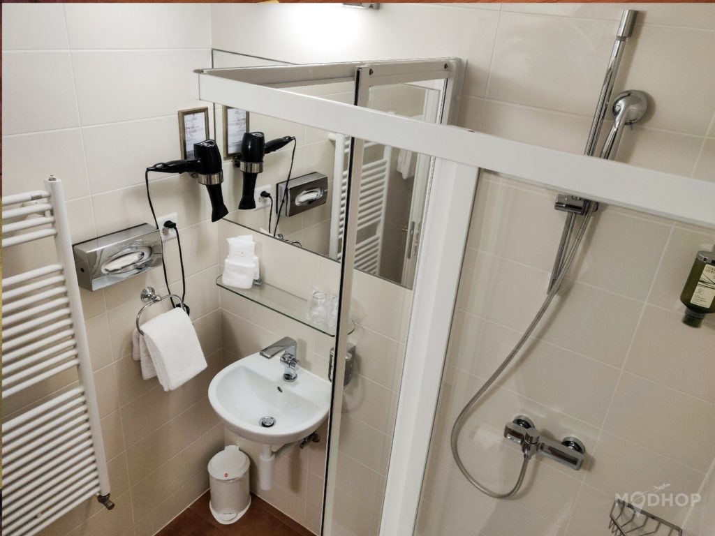 a bathroom with a shower and a shower unit