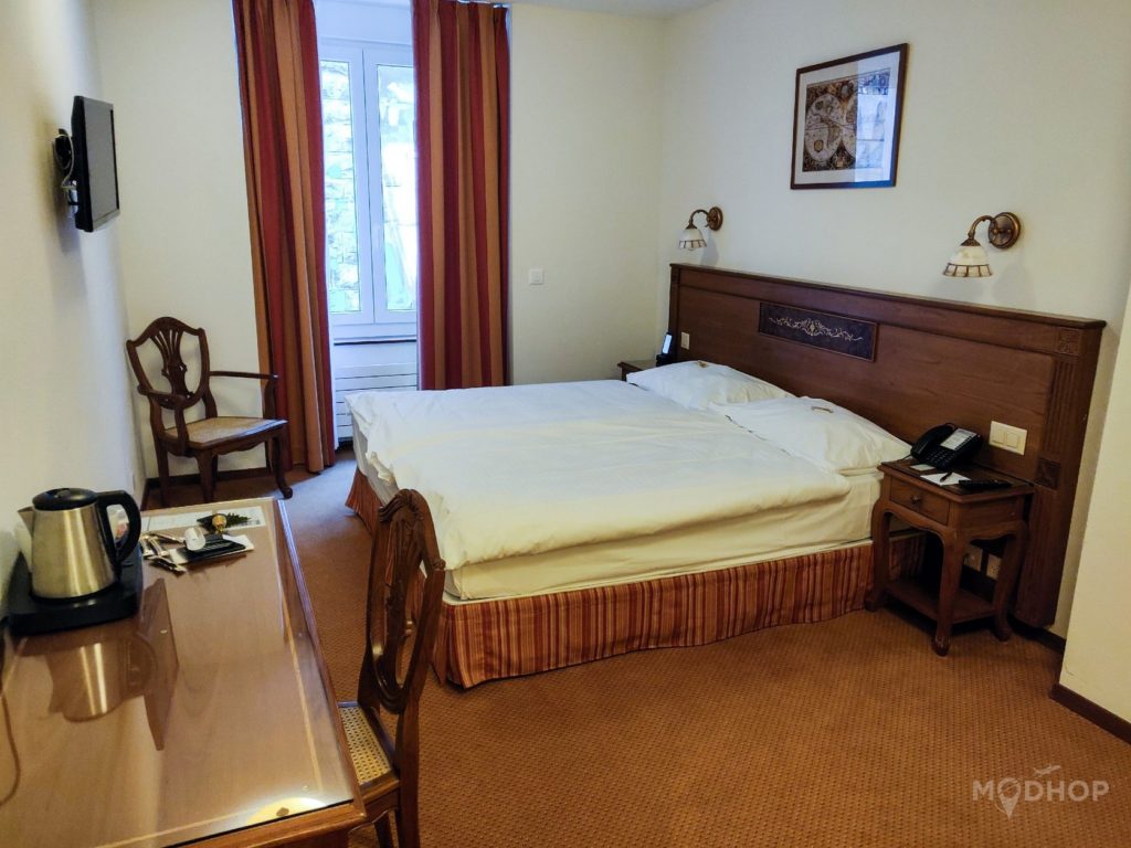 a room with a bed and a desk