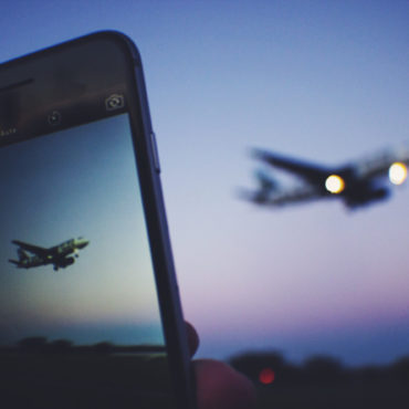 a phone taking a picture of an airplane