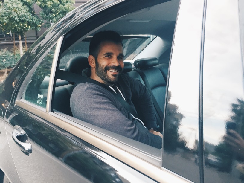 a man sitting in a car smiling