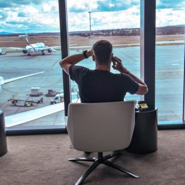 a man sitting in a chair at an airport