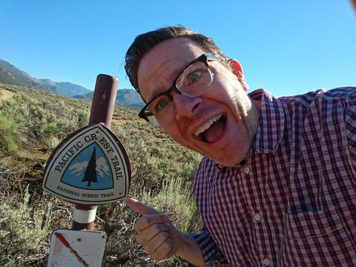 a man pointing at a sign