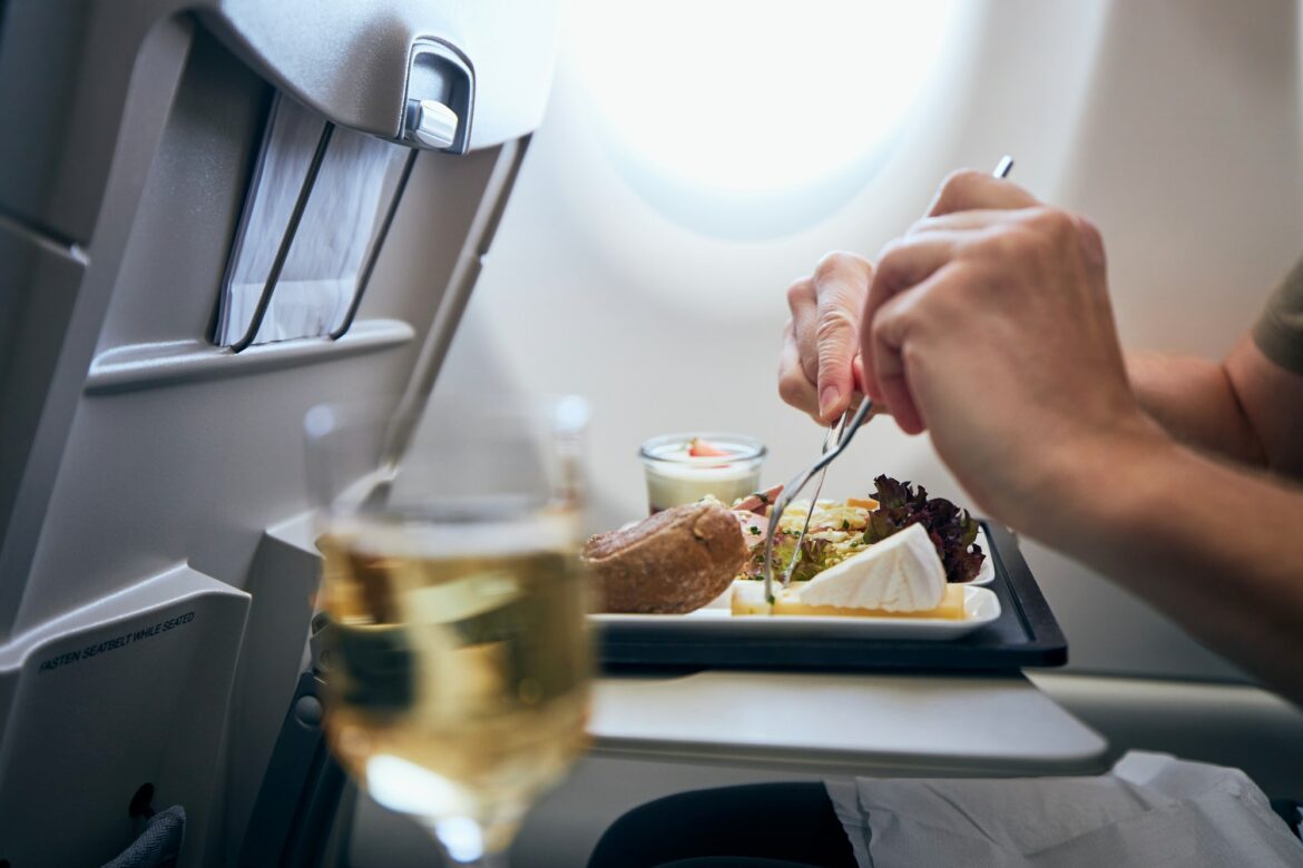 Airline meal and beverage served on seat tables during flight.