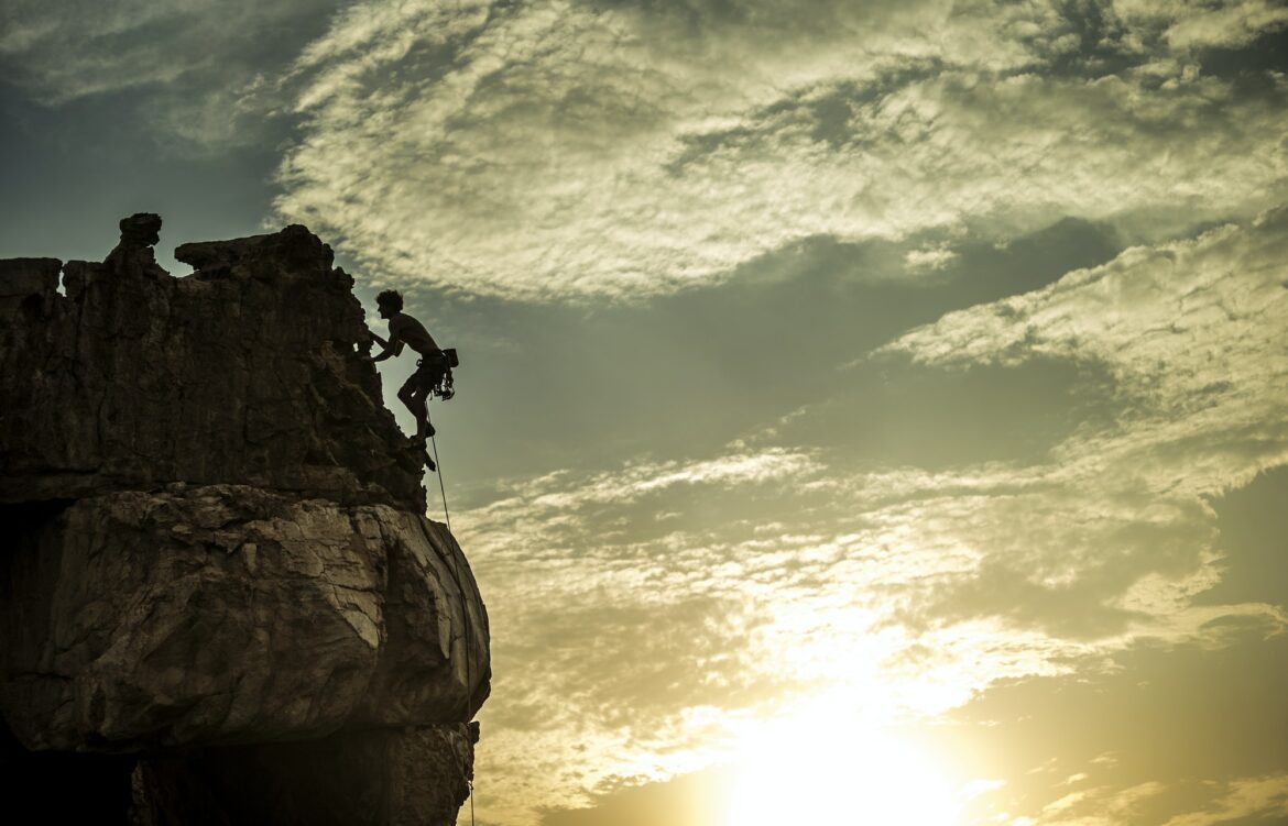 Mountaineer climbing a rock formation.