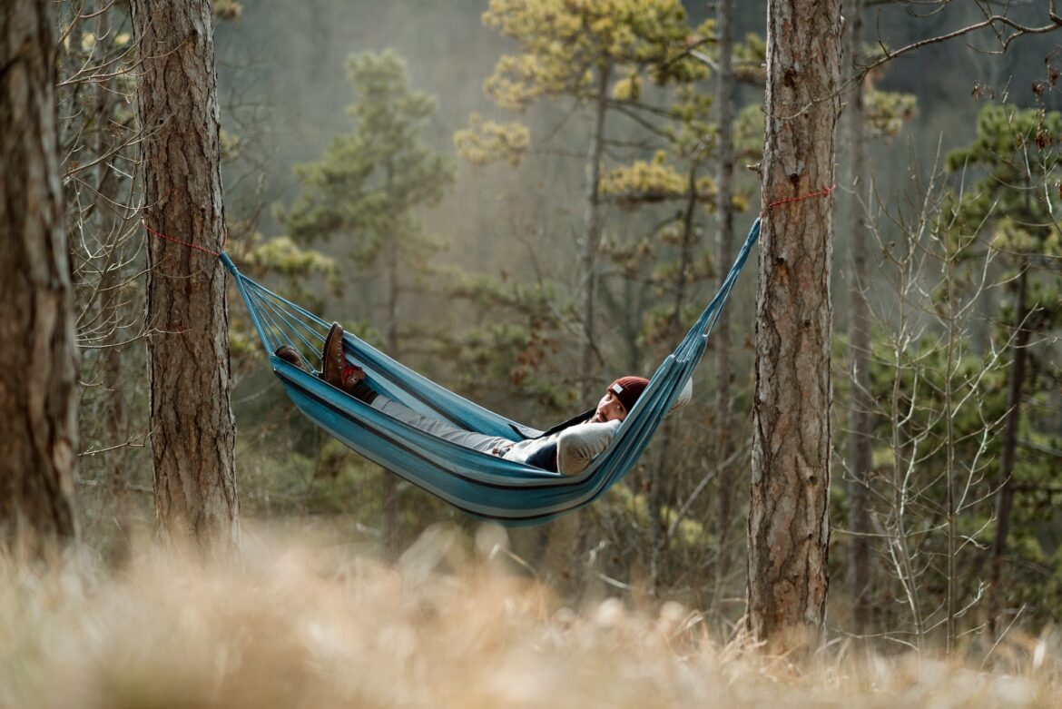 Young man resting in hammock, outdoor lifestyle