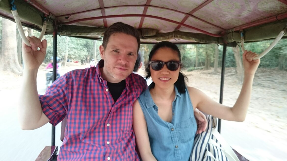 a man and woman sitting in a vehicle
