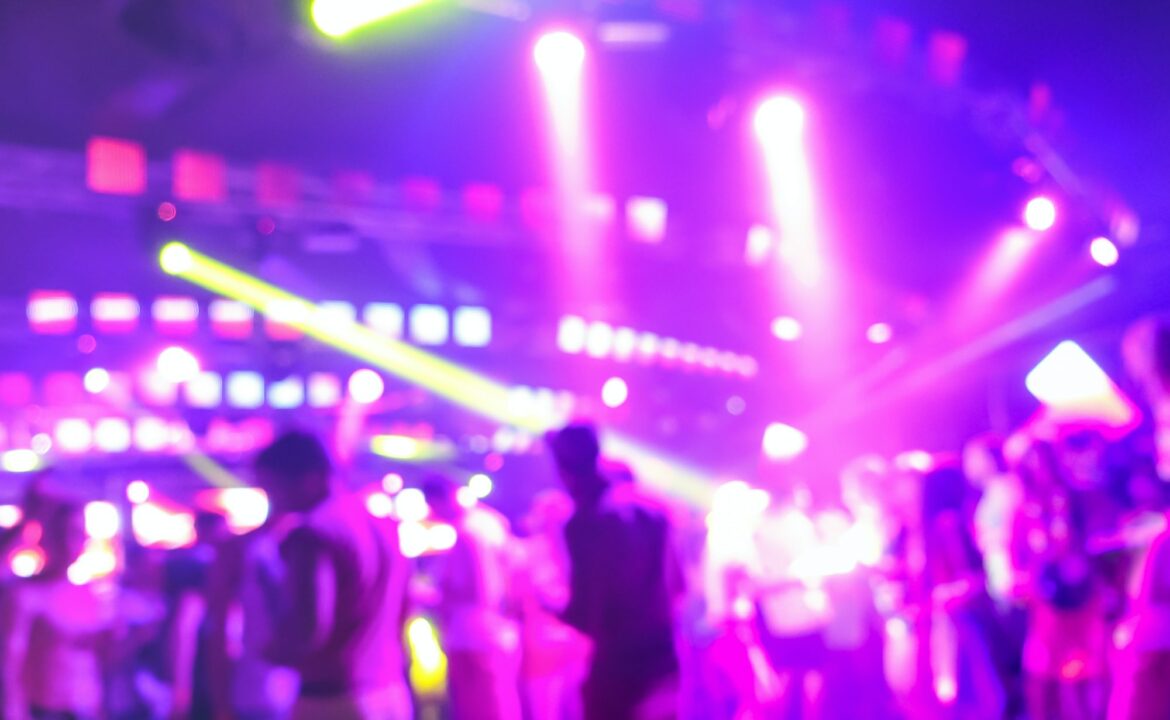 Blurred people dancing at music night festival event