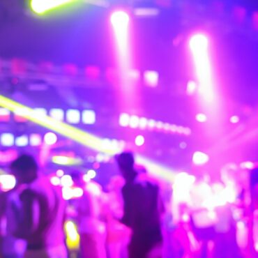 Blurred people dancing at music night festival event