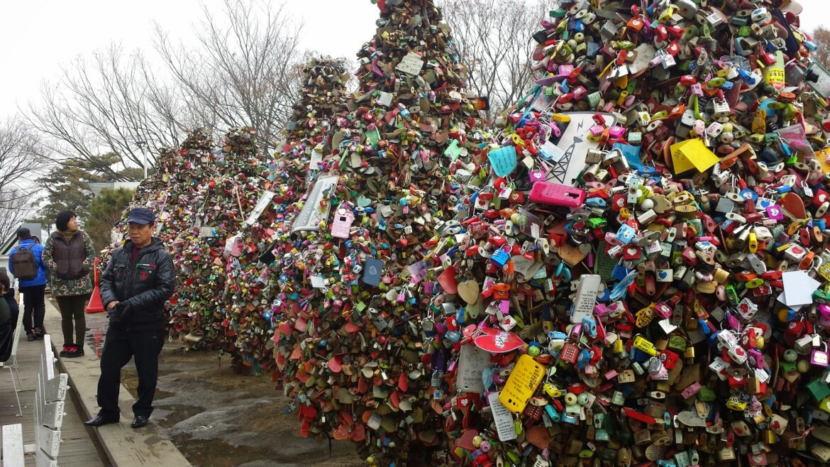 a group of locks on a tree with Bubblegum Alley in the background