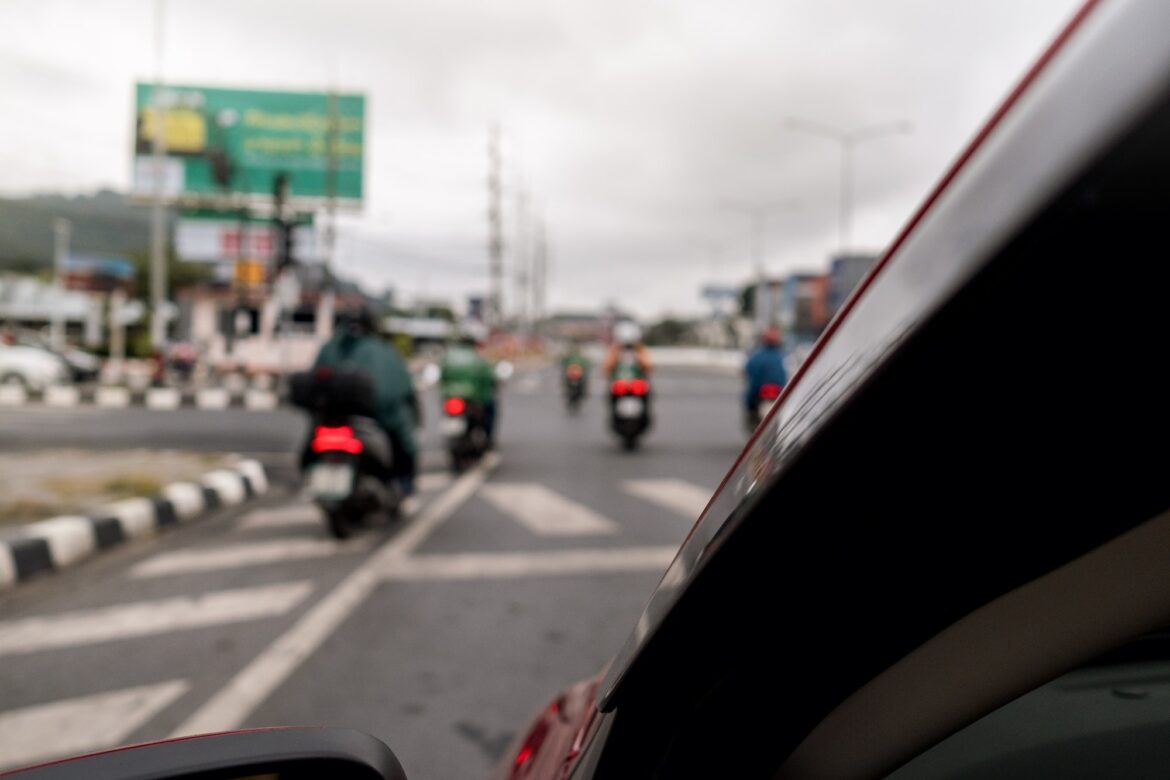 Motorcycle traffic on Phuket Island. Defocused background