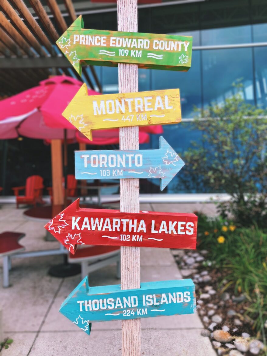 Colorful directional sign in southern Ontario at on route stop
