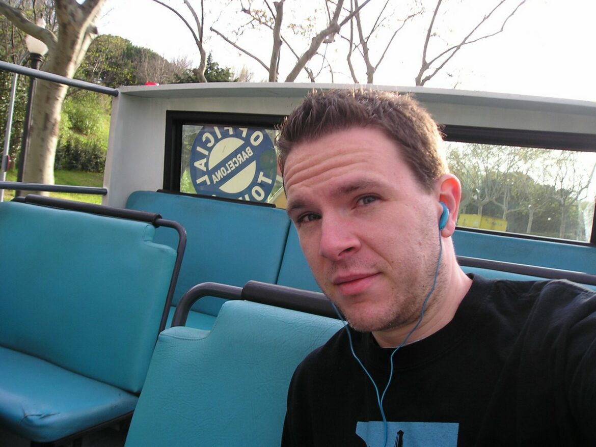 a man sitting on a bus wearing headphones