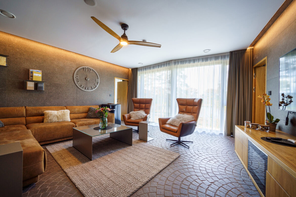 a living room with a fan and couches? yes please. our hotel room upgrade tips