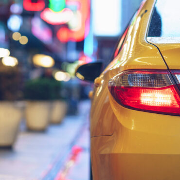 Yellow car in the city. Should you get the credit card rental car insurance?