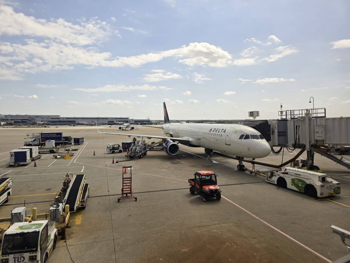 We see a Delta plane parked at gate while abiding by the Centurion Lounge guest rules 2026 updates.